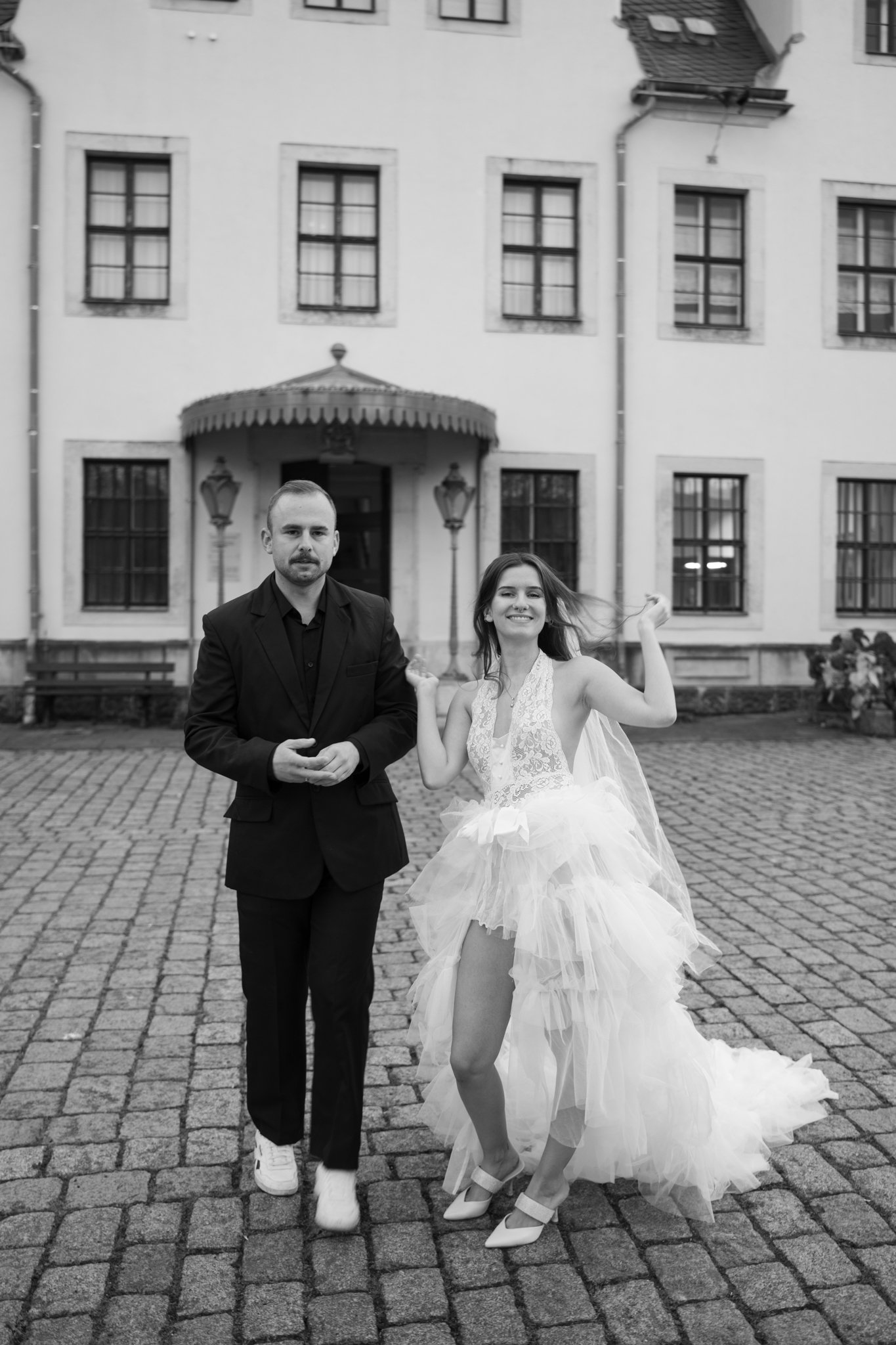 nick and clara outside of castle, laughing and walking