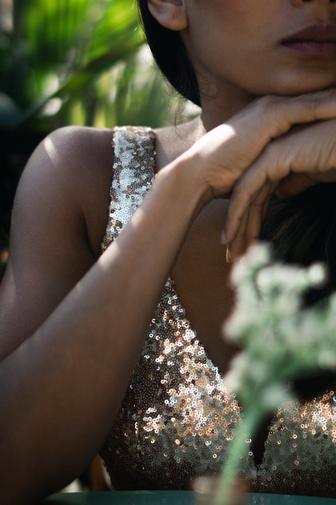 Woman with glittering top and hand