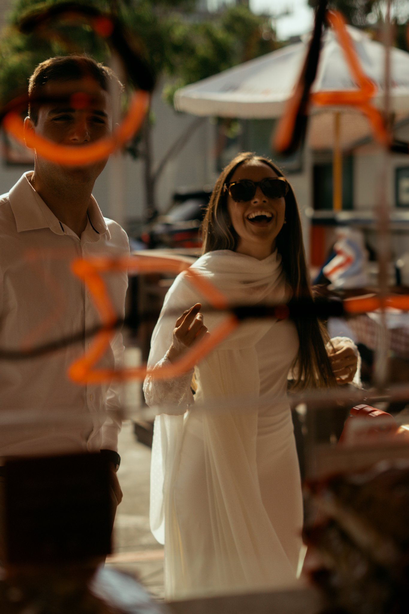 view from inside the shop throgh the window. Bride laughing