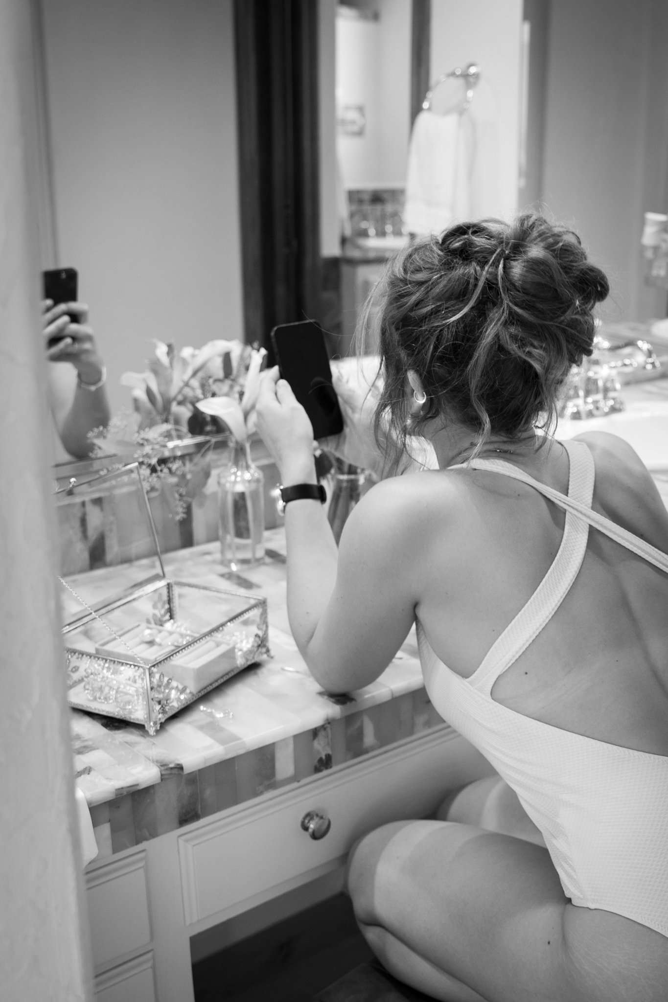 woman getting ready infront of mirrow