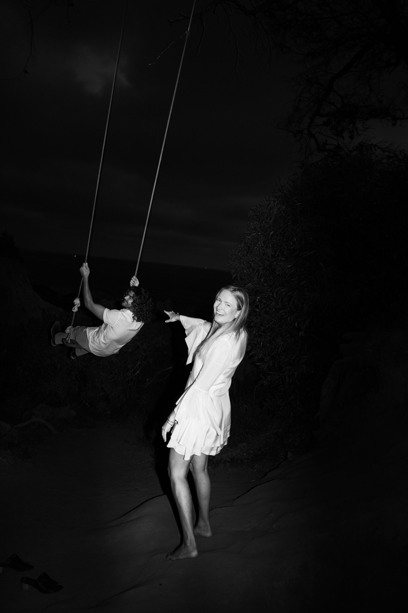 man and woman swinging on swing