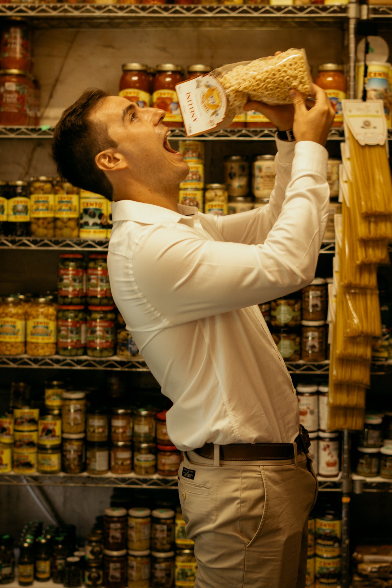 Man is acting like he is eating pasta out of box