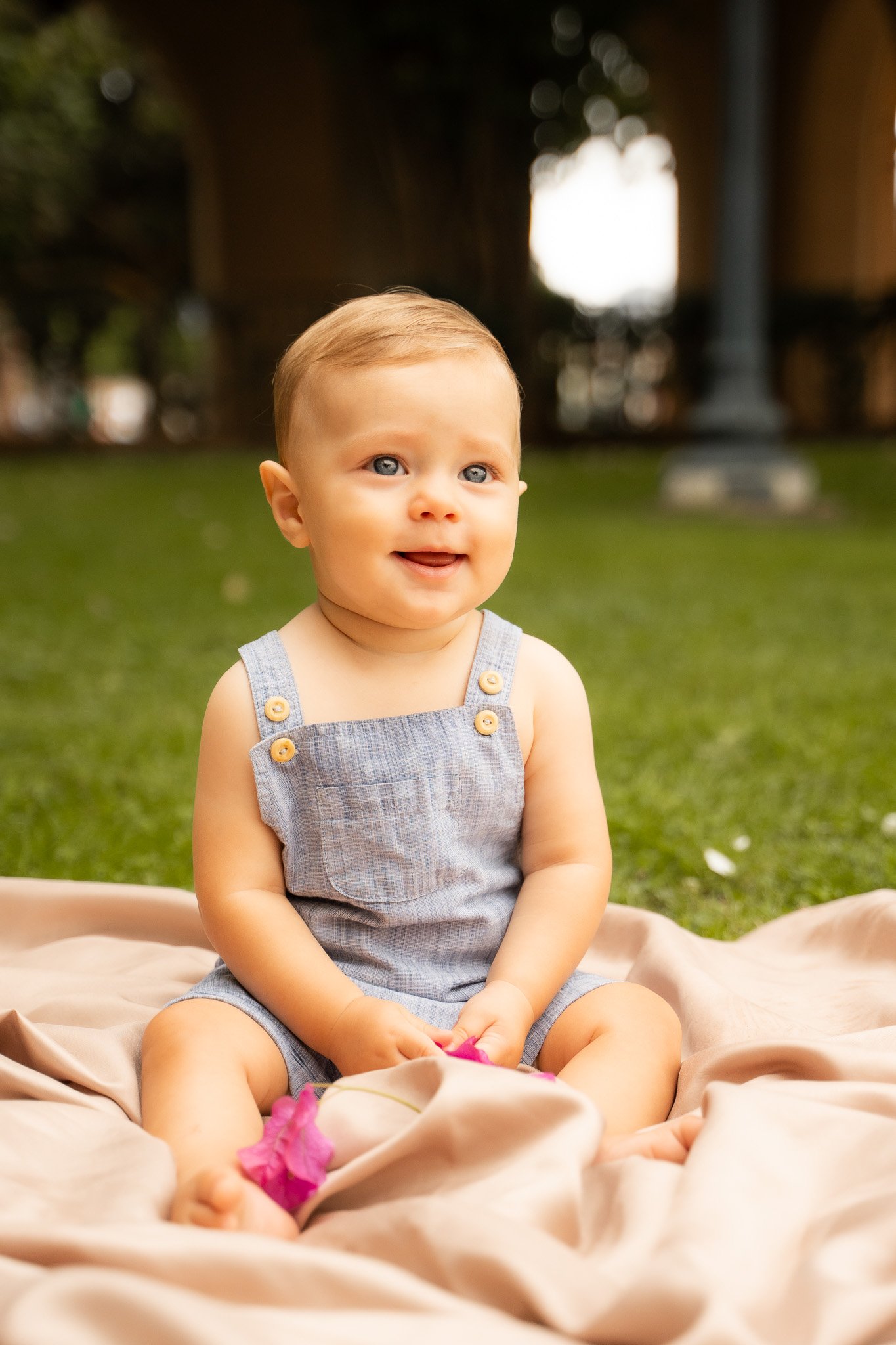 baby sitting on blanket and laughing