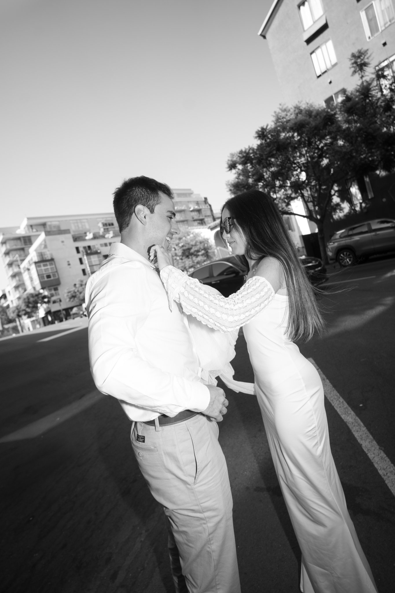 Bride and Groom on Sidewalk in San Dieo, Bride holding Grooms face