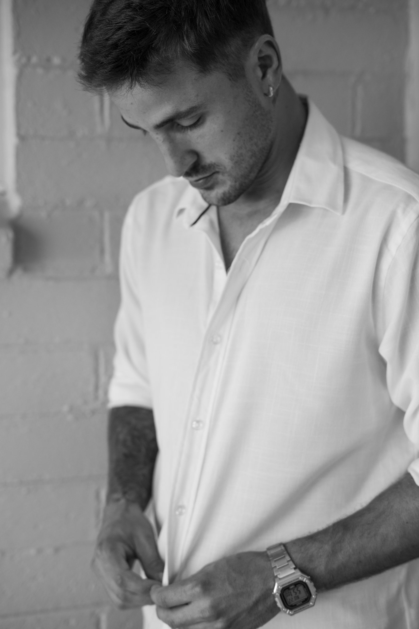 Man closing his Shirt.