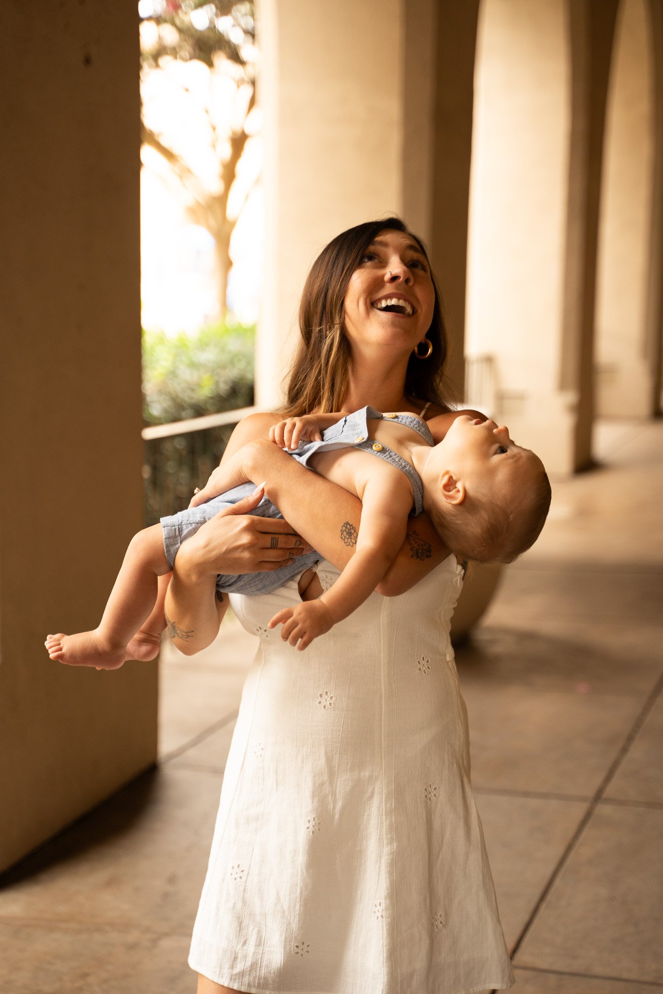 Woman holding baby, baby is looking up and mother as well