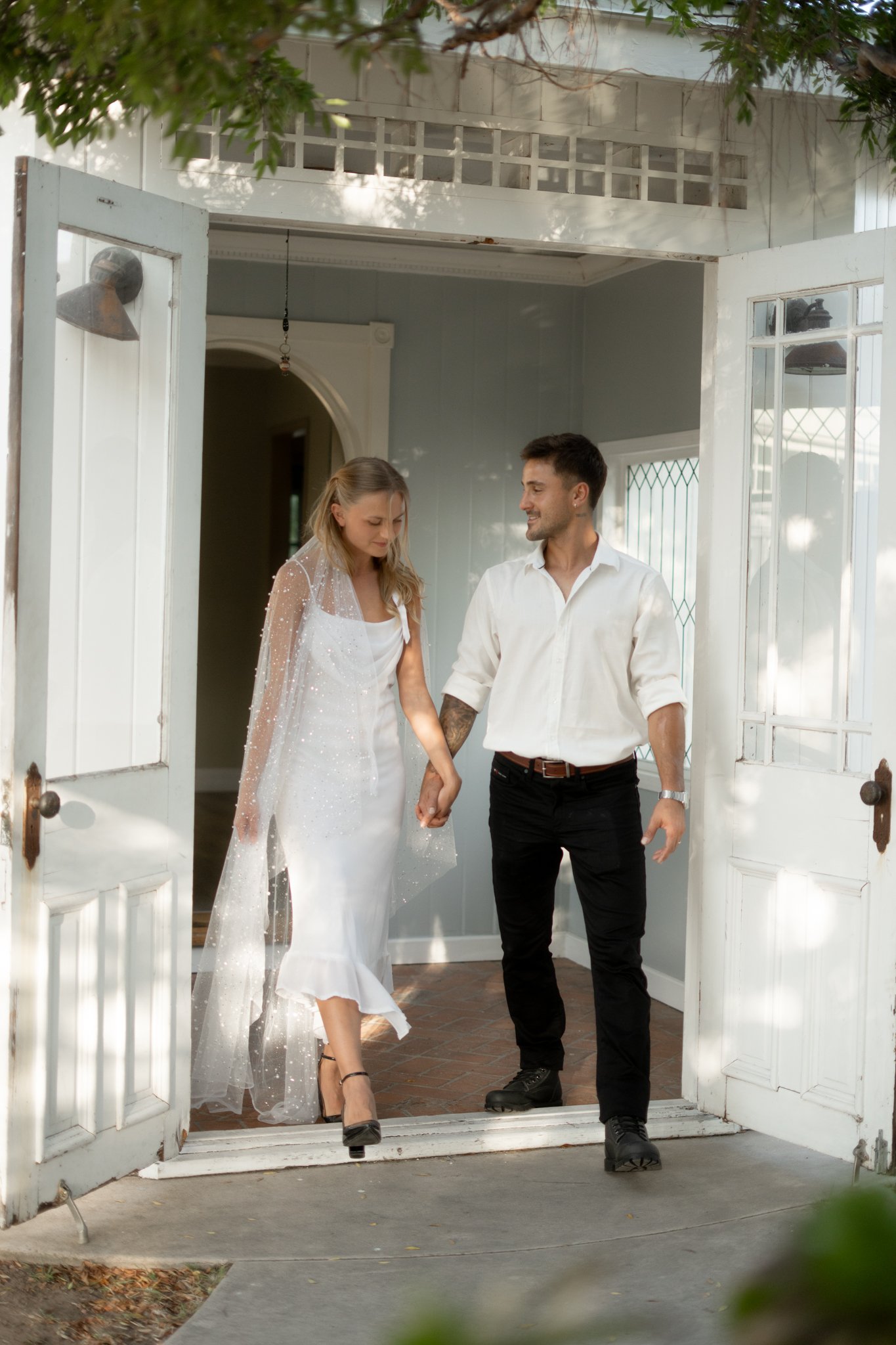 Man and Woman, newly wedded, walking outside house in ice clothes (wedding)