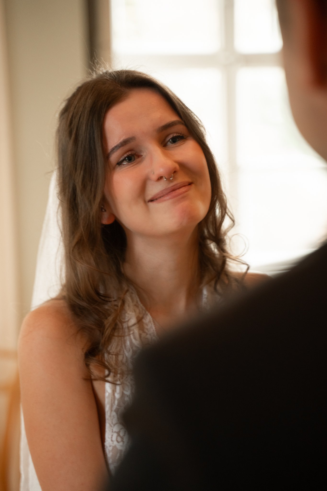 Clara looking at her groom as he is saying his vows