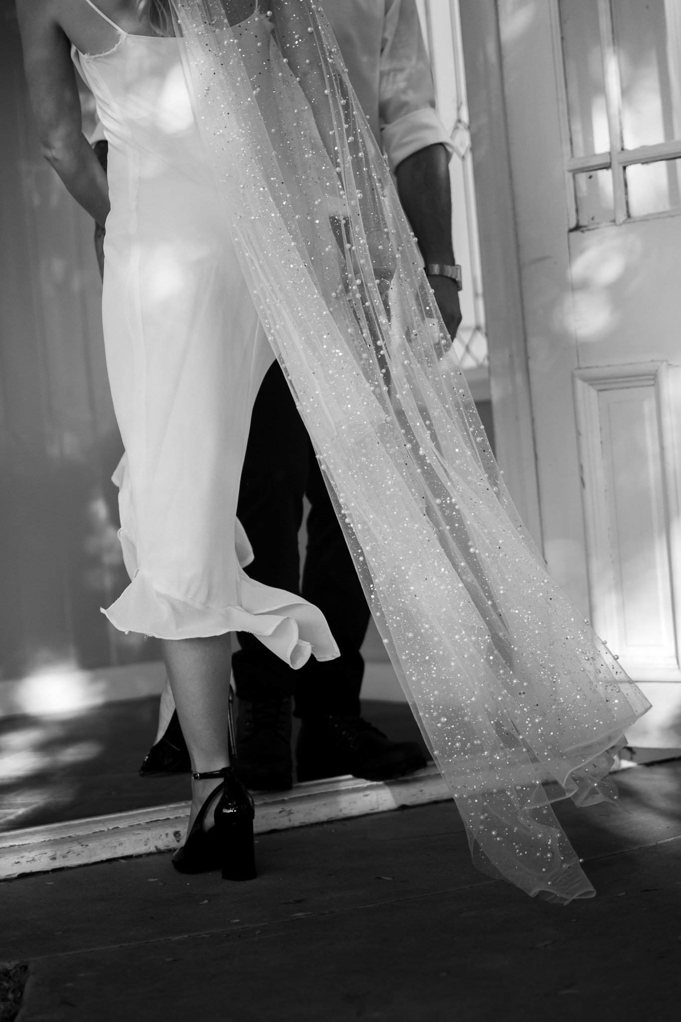 close up from vail and back of bride