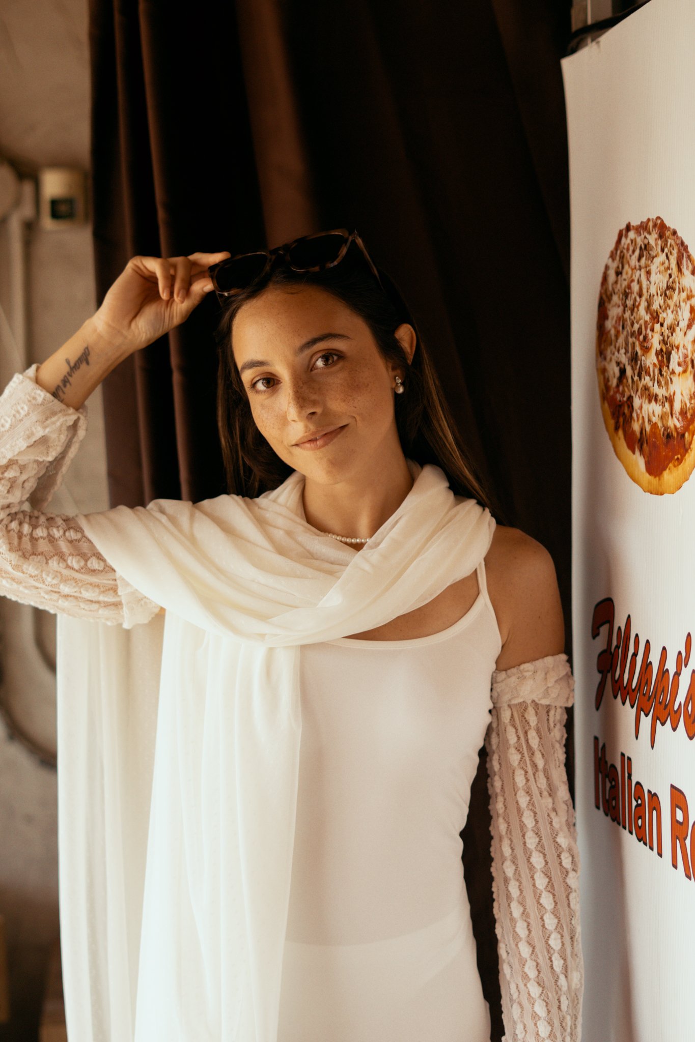 Bride looking at camera amd touching her sunglasses