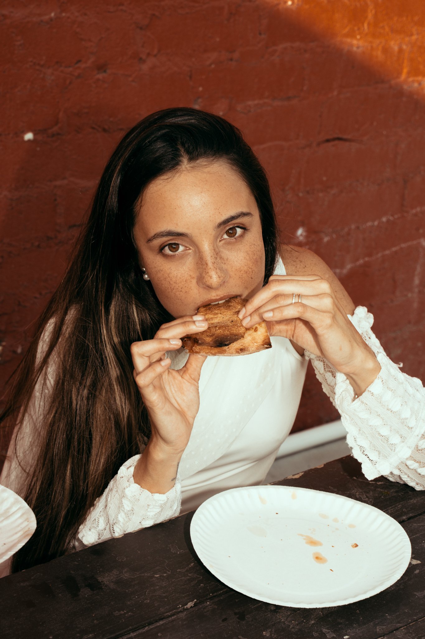 Bride eating Pizza and looking into the camera
