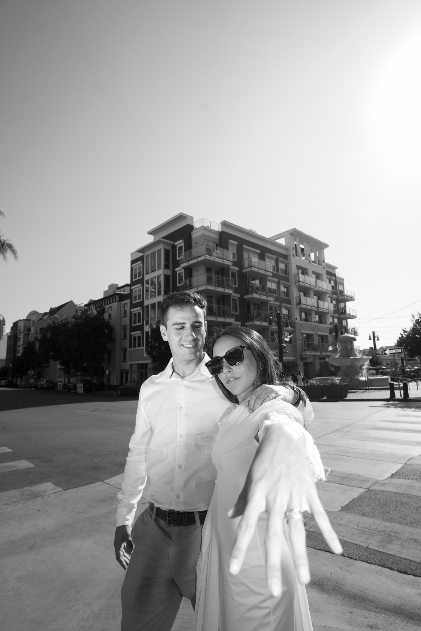 Marle is holding her Ring into the Camera. Pedro and Marle walking over the street