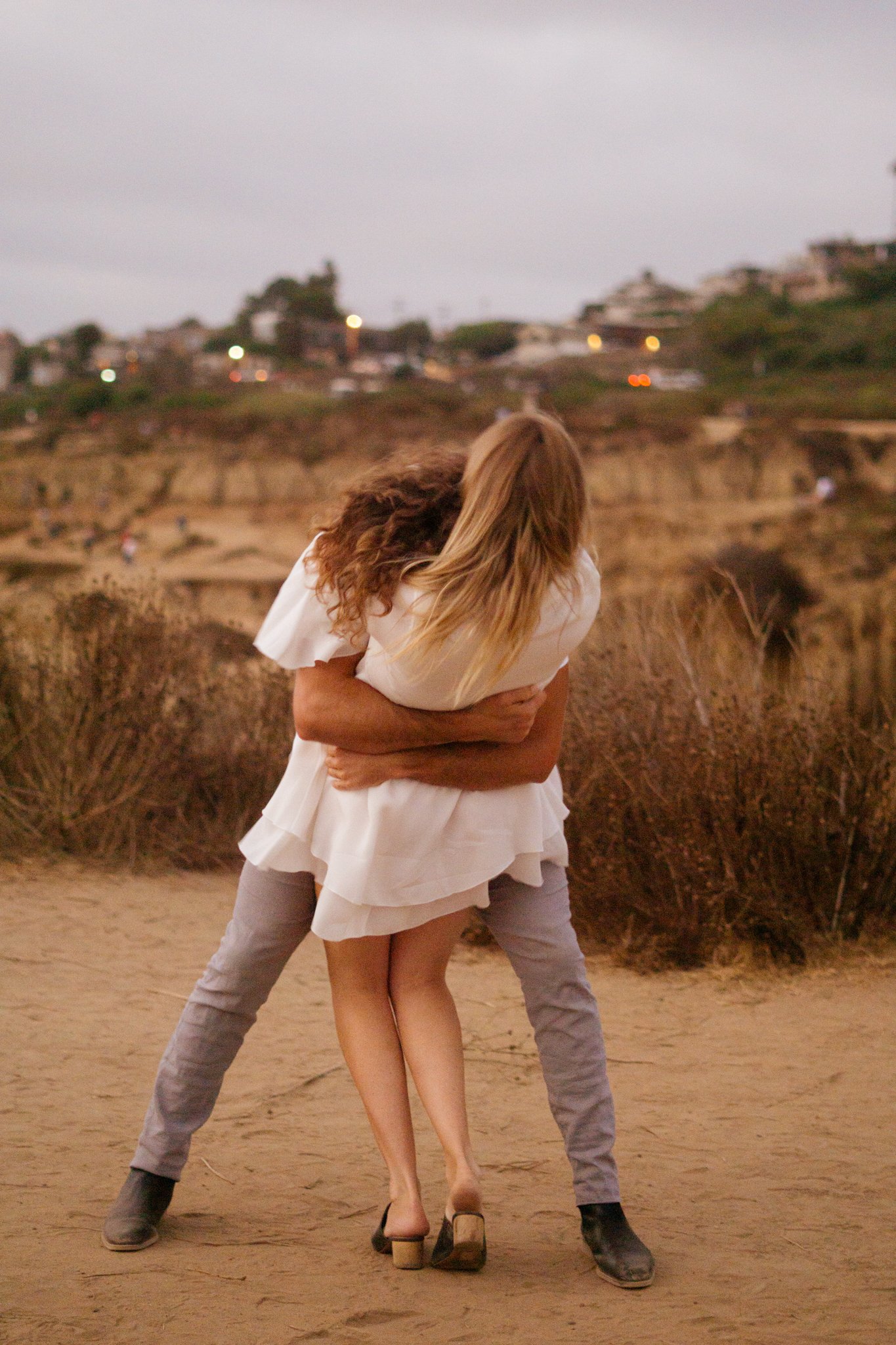 Man is holding woman tight and having fun