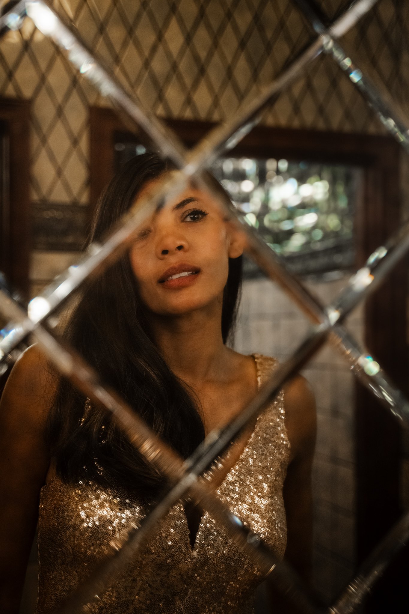 Woman in a glittering dress in front of a mirror