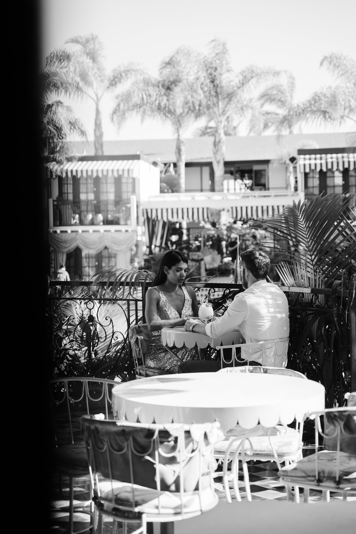 Two people sitting at a table outside.